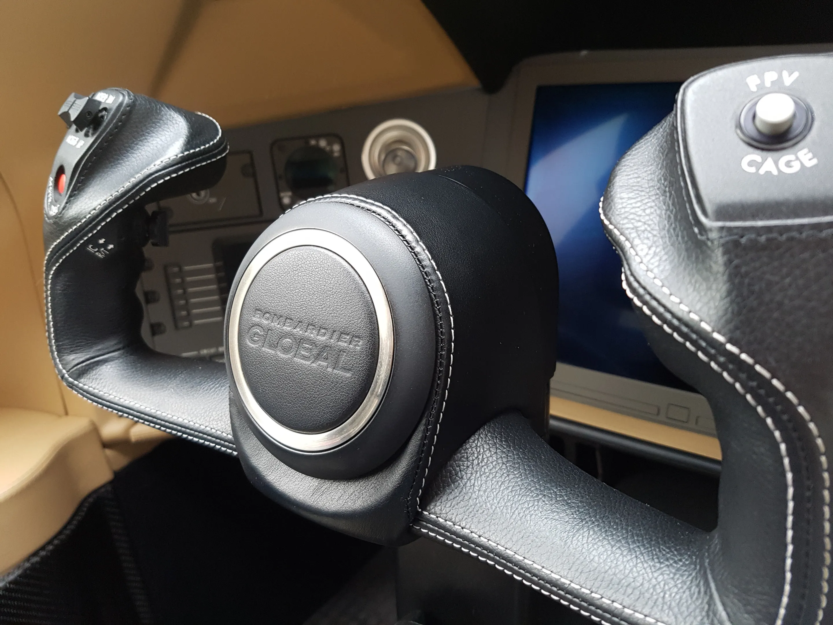 The leather-wrapped control yoke of a Bombardier Global flight deck.