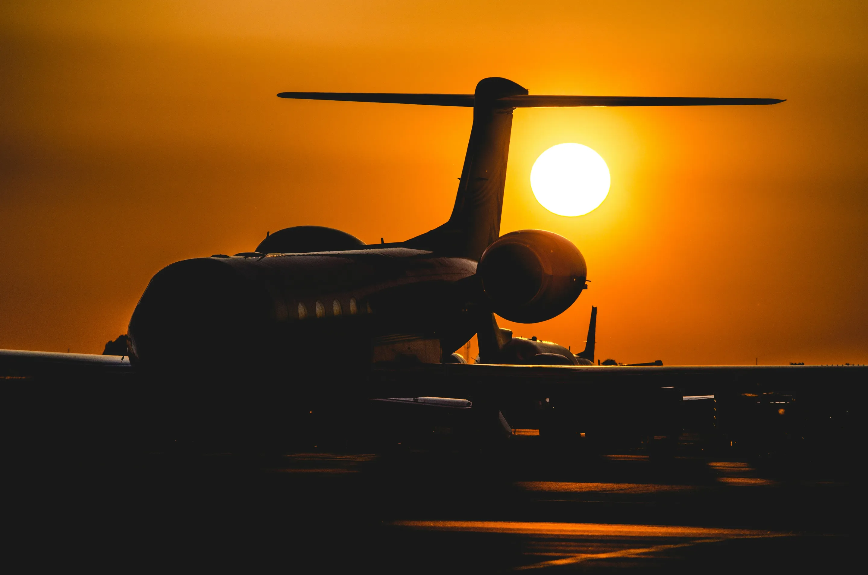 A Gulfstream silhouetted against the setting sun.